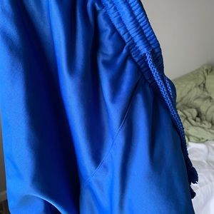 Comfortable and fitting blue track pants.